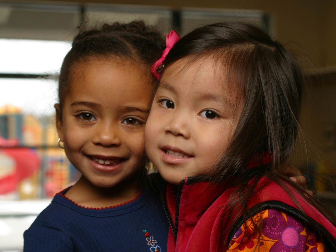 Two toddler girls smiling