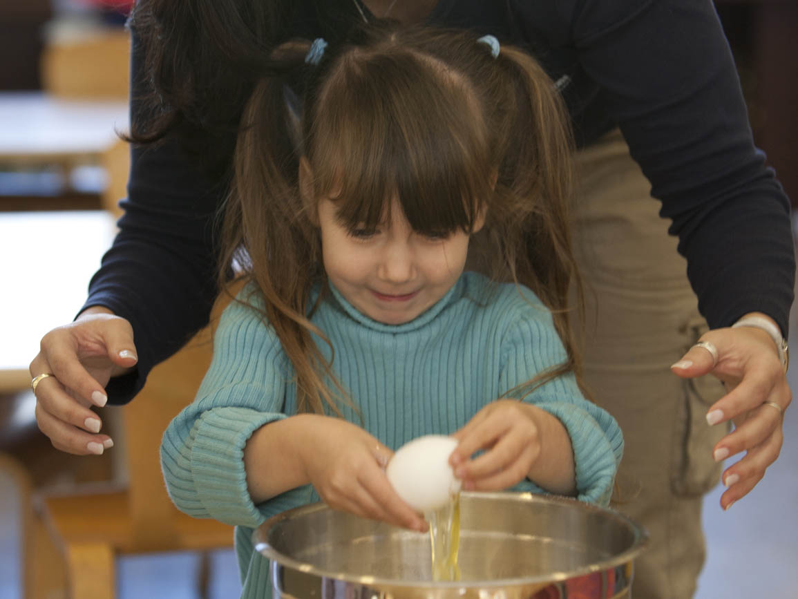 a child cracking an egg