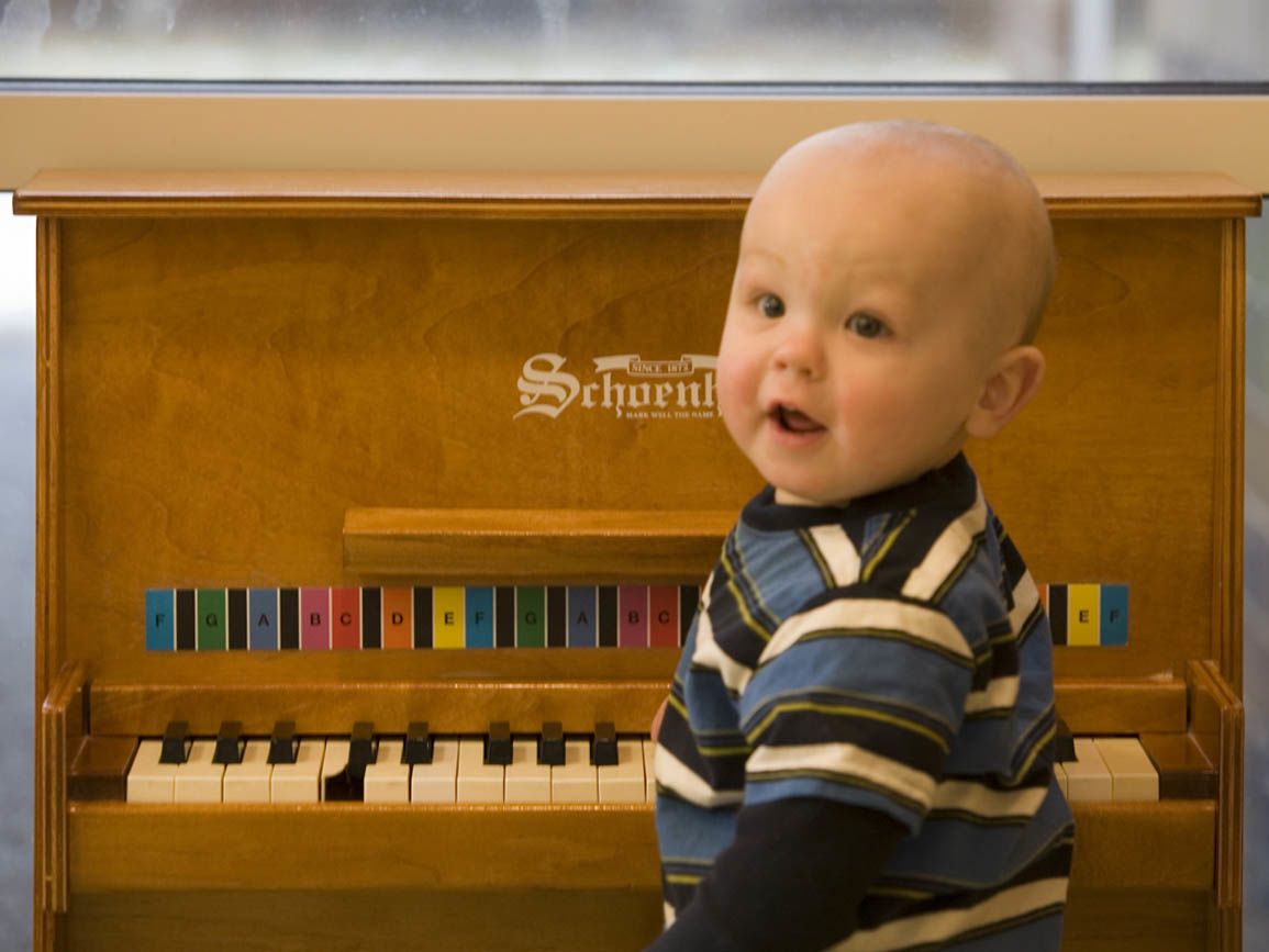 An infant at a piano