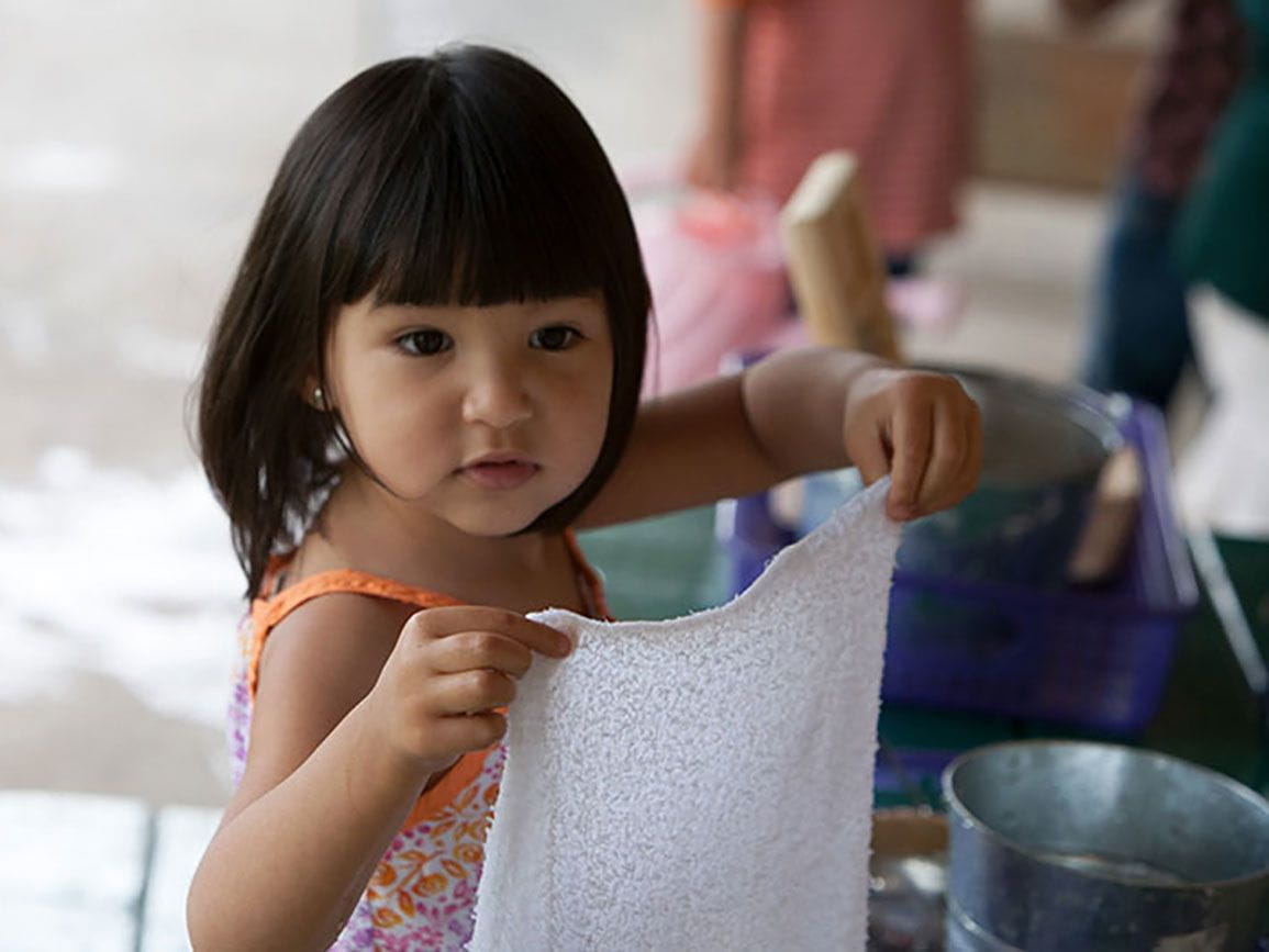 Preschool aged girl holding a wash cloth