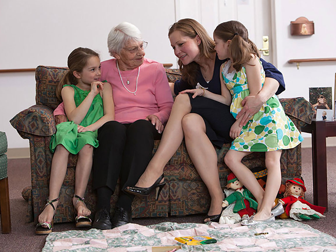 Grandma, mom, and two daughters together on the couch