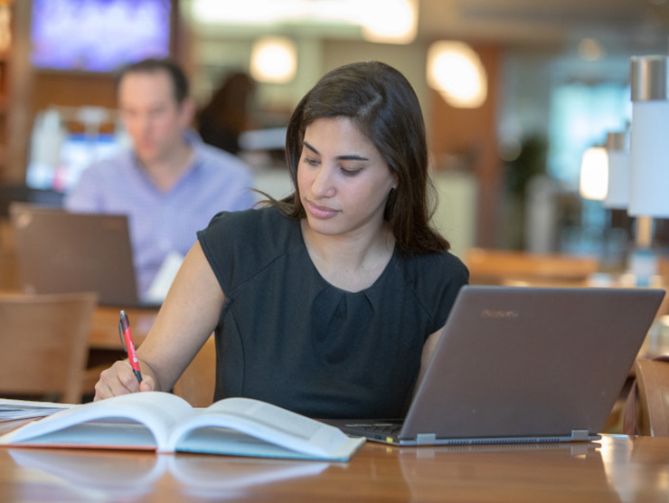 Young professional woman taking an online undergraduate course