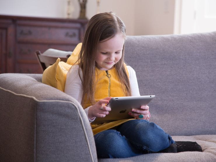 little girl looking at tablet