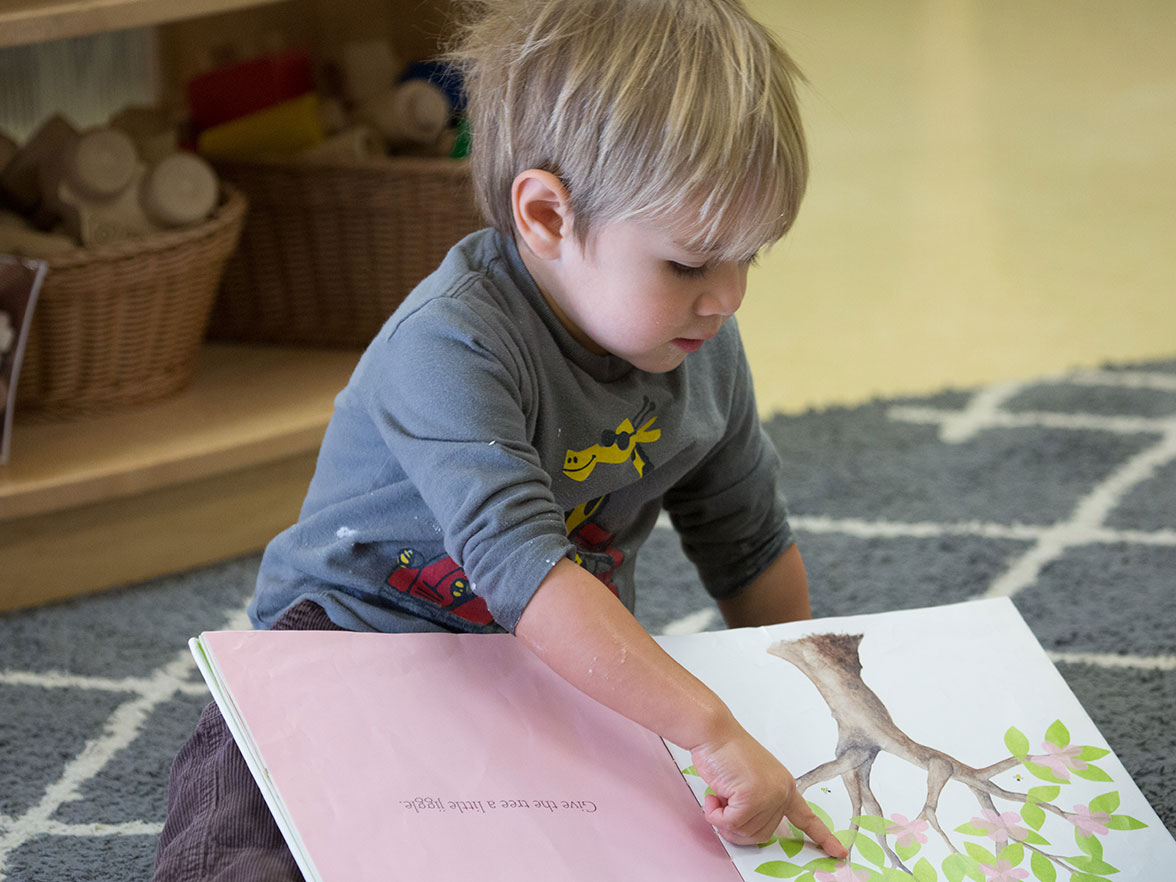 Young child at daycare learns to read through the Bright Horizons Growing Readers literacy program, ready to read