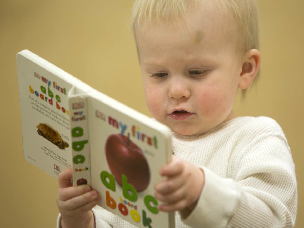 Infant holding a book