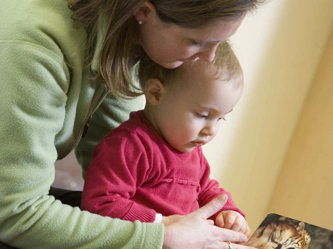 Mom reading with her infant girl