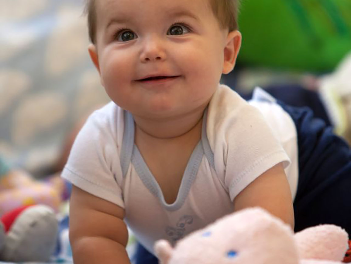 Baby smiling at toys