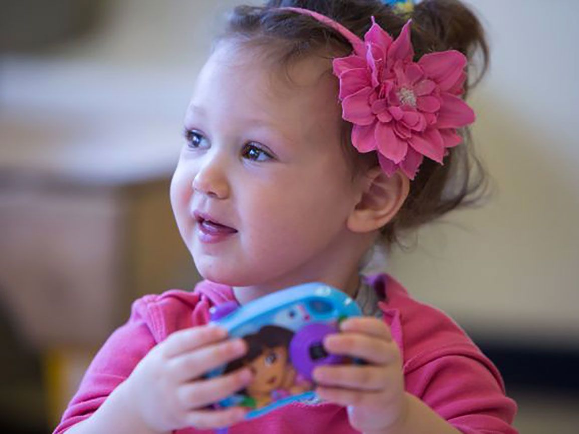 Toddler girl holding a toy