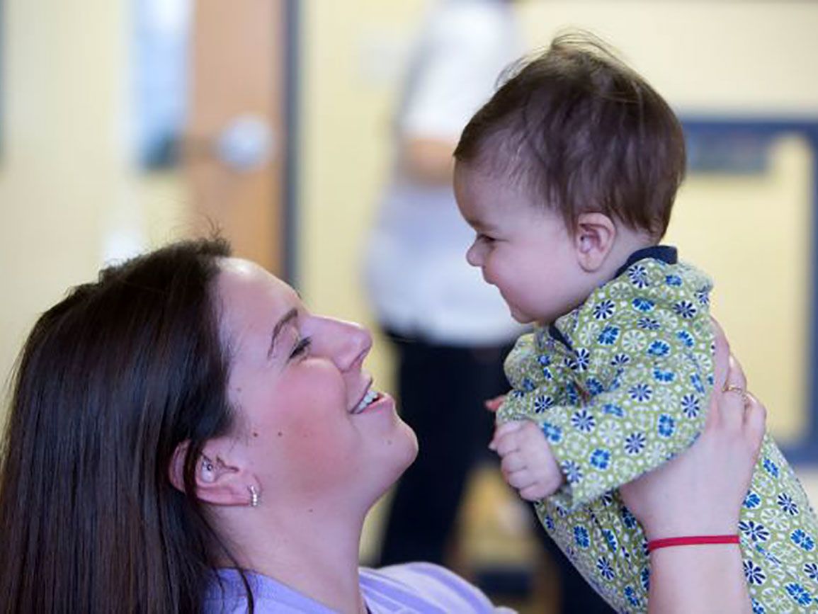 Mother holding a talking baby