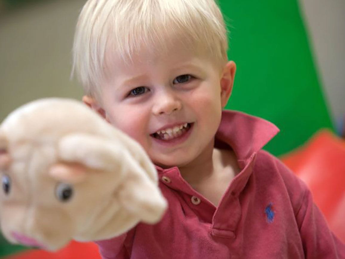 Preschool boy holding a puppet