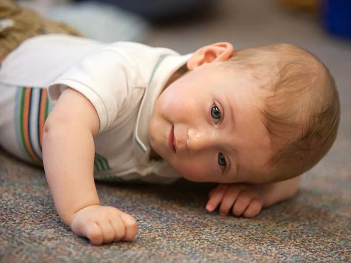 Baby crawling on a rug