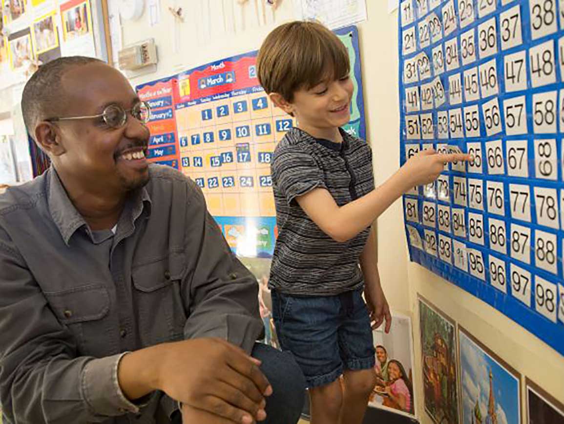 Teacher and boy pointing to calendars