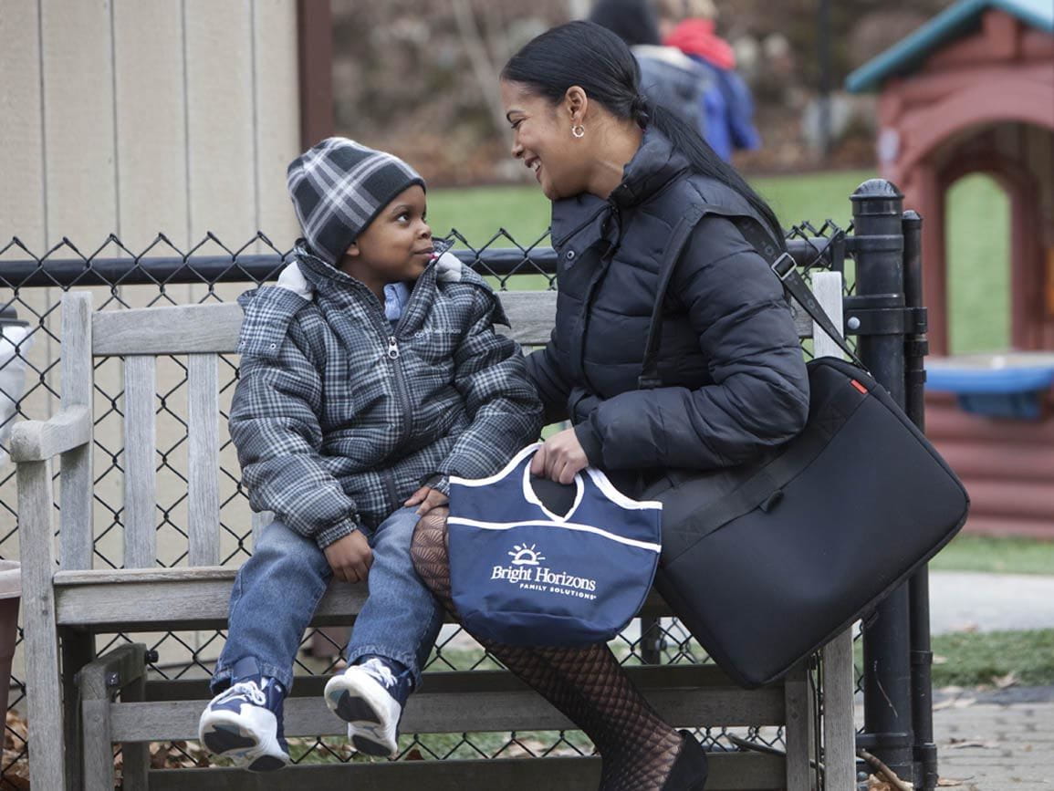 A mother dropping off her child at child care before work