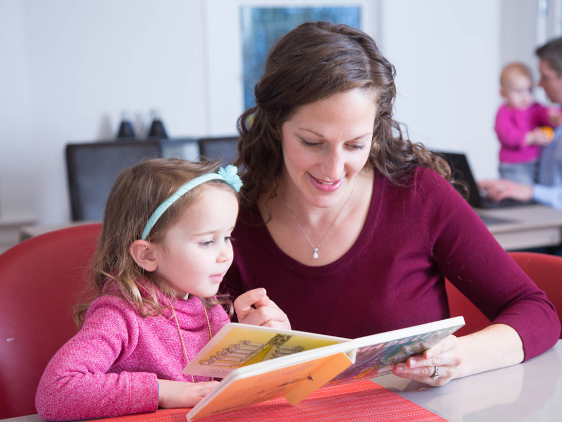 A mother and daughter reading a book together