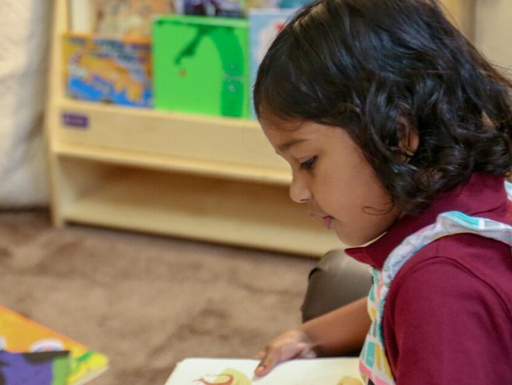 Child reads educational books at child care center