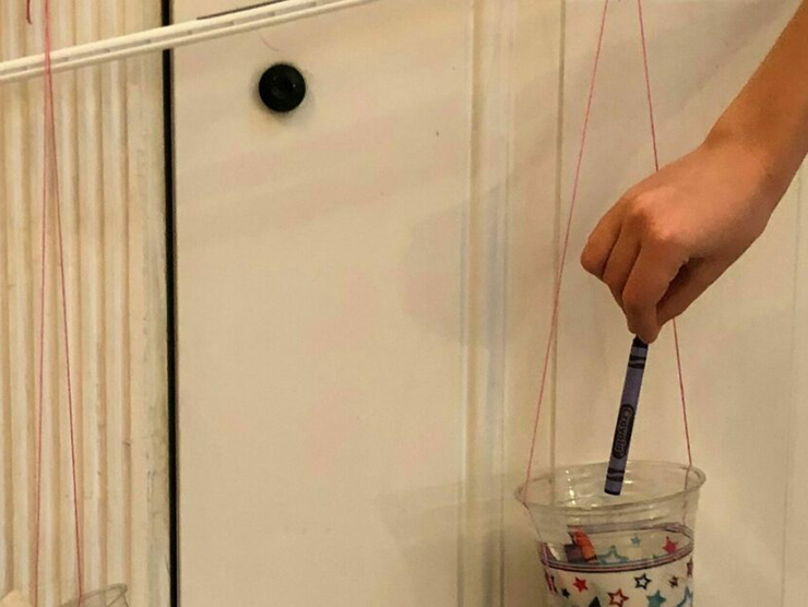 Toddler learning to balance cups by investigating numbers and new concepts home