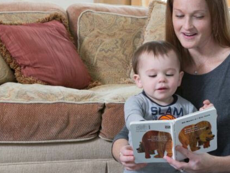 Mother and son reading a picture book about animals together 