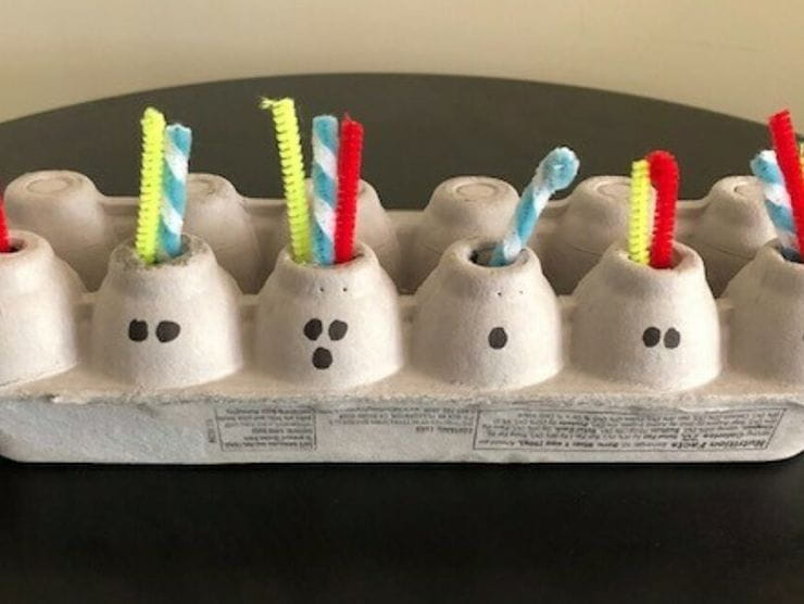 Egg carton and pipe cleaners used for counting game 