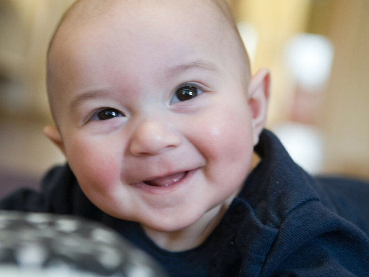 Infant smiling during playtime at day care 