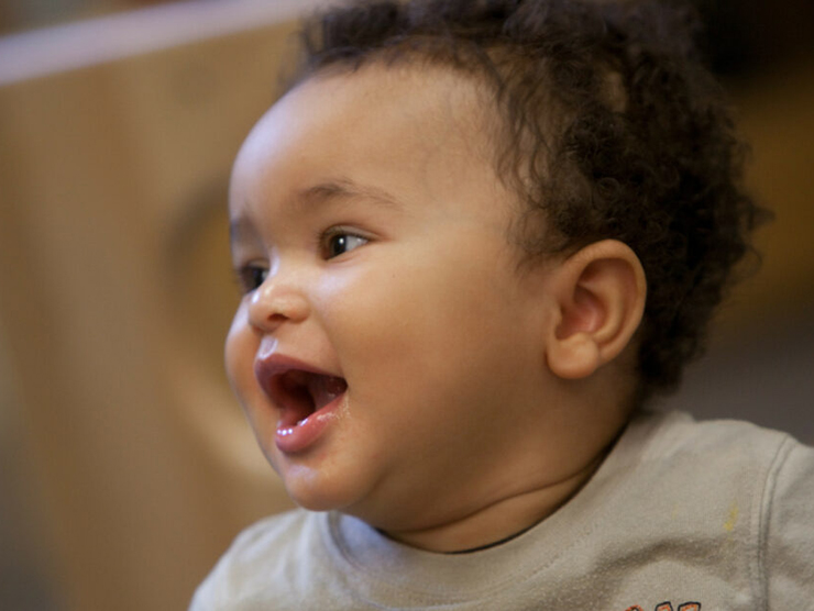 Infant laughing while playing at day care 