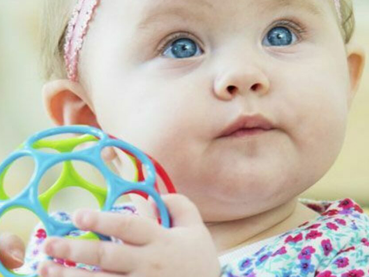 Infant playing with a toy at day care 