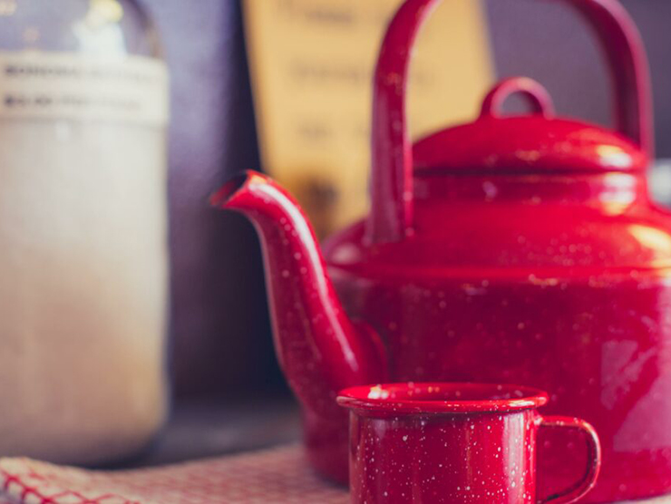 Red teapot and teacup in kitchen