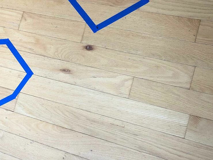 Shapes lined out in tape on hardwood floor at Bright Horizons day care 