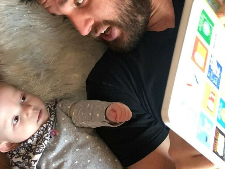 Father reading to infant at home 