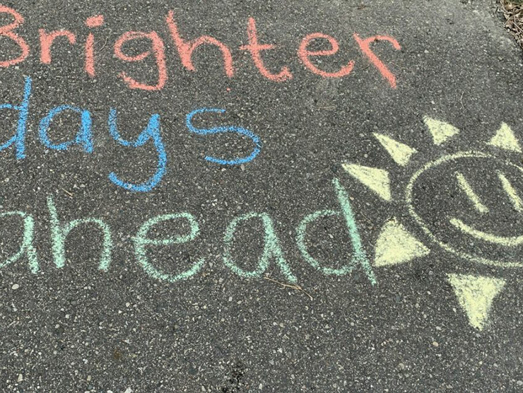 Brighter days ahead written in chalk on a sidewalk 