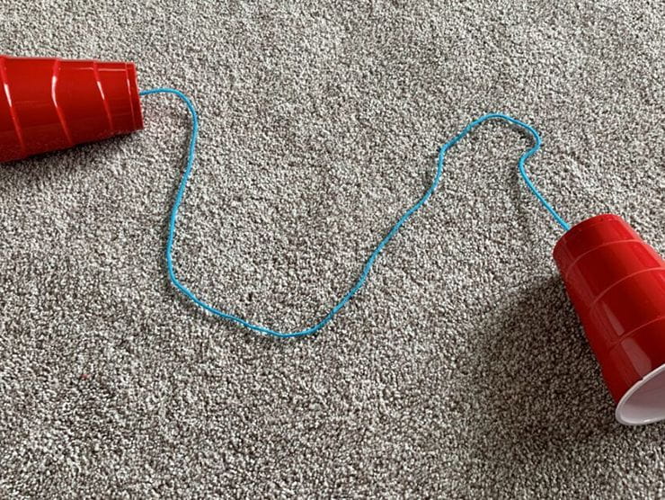 Plastic cups connected by a string to make a telephone 