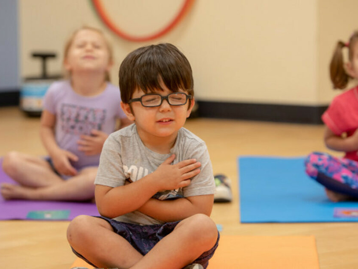 Little boy practices meditation at daycare