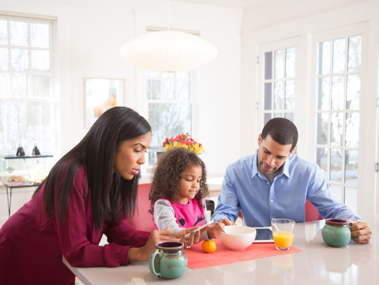 Family with child at breakfast table