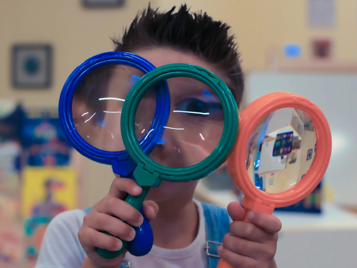 Child playing with magnifying glasses