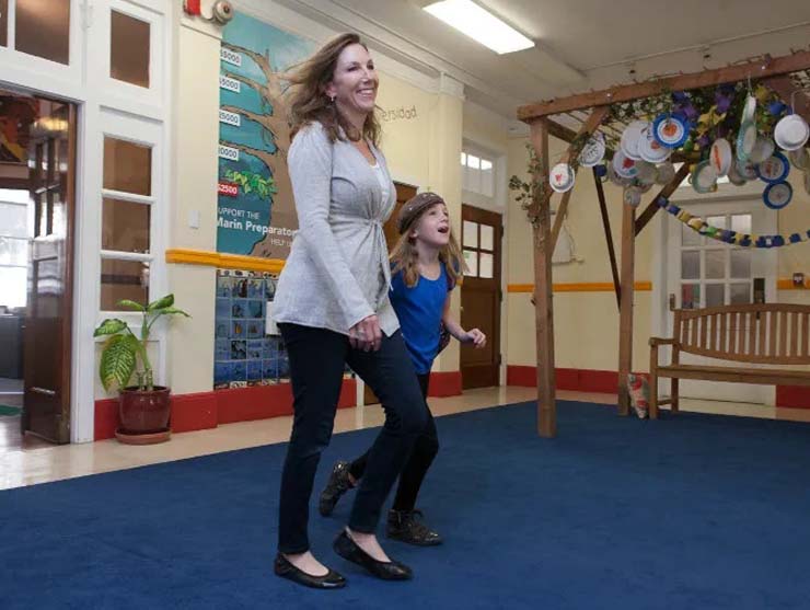 Mom walking kindergarten-aged daughter to school