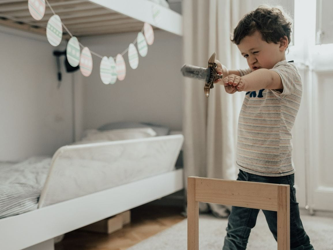 Child playing with toy sword