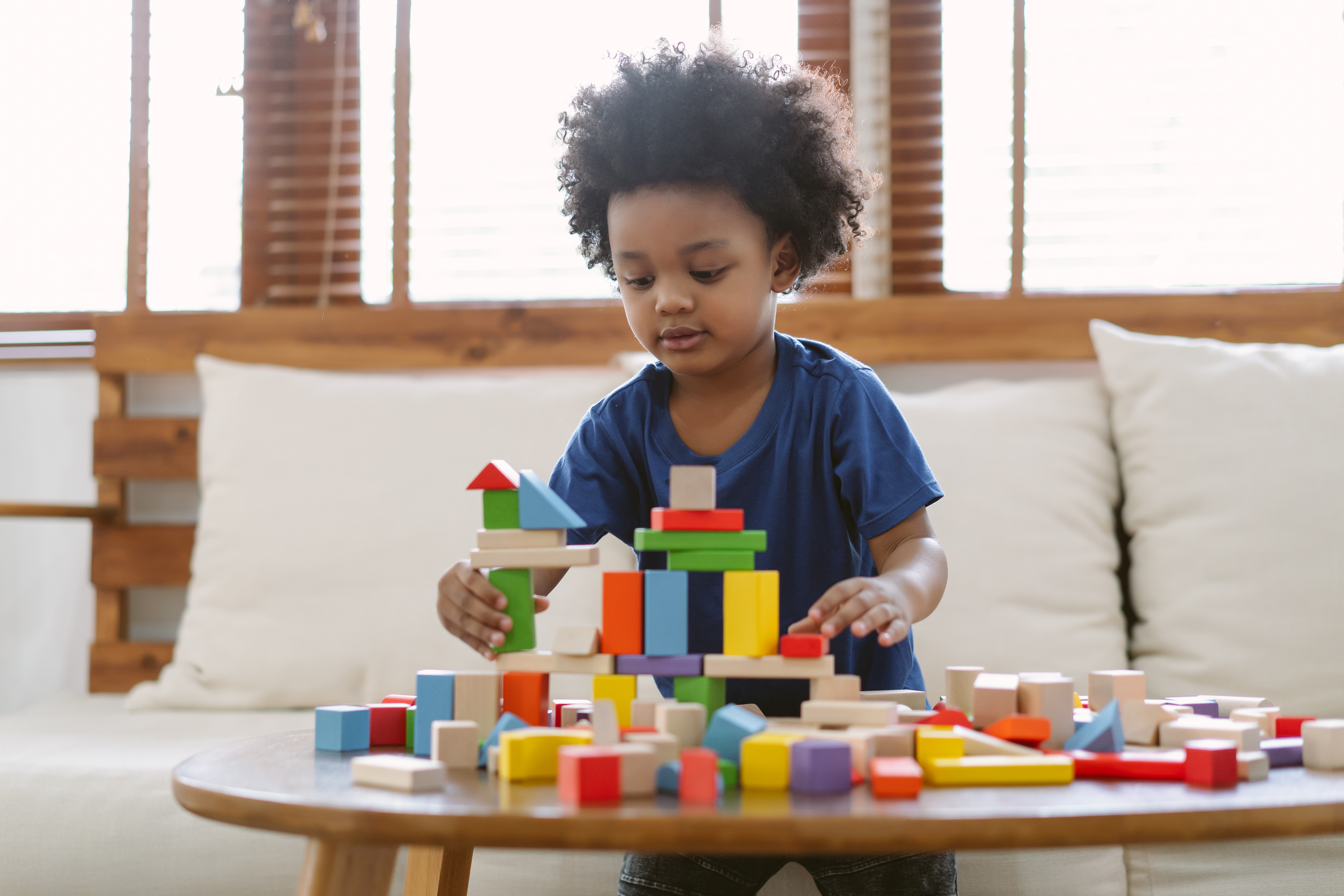 A child playing blocks in the family living room