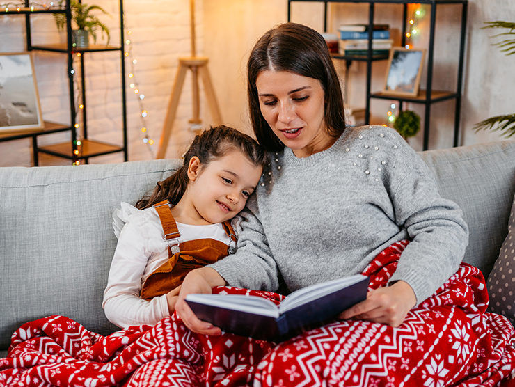 Mother and daughter reading together during the holidays