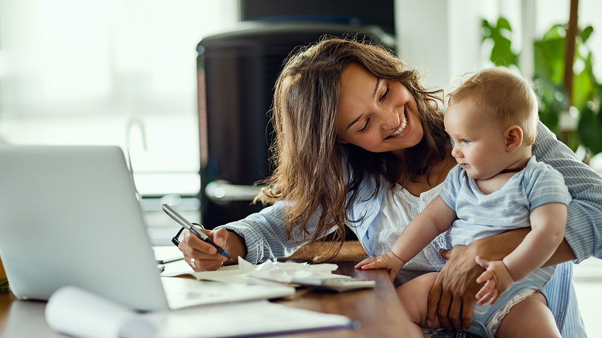 Working mother balances work and life as she cares for infant at home