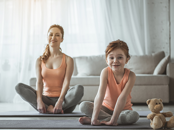 mom and daughter exercising in a home office