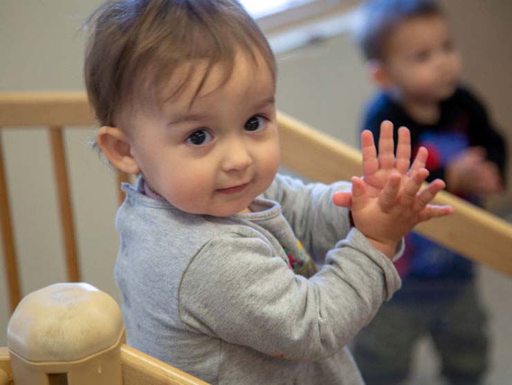 baby using Sign Language in a Bright Horizons infant classroom