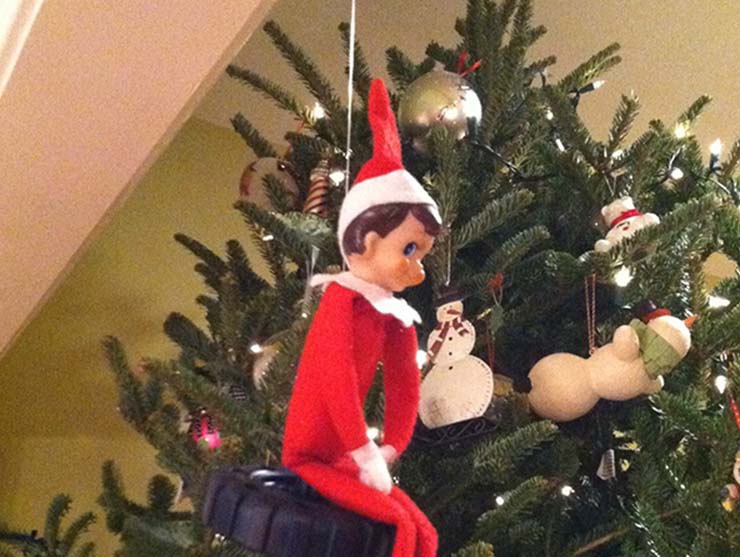 The Elf on the Shelf in front of a Christmas Tree|Elf on the Shelf caught moving|||