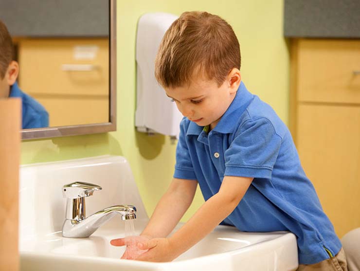 Boy washing his hands after potty training