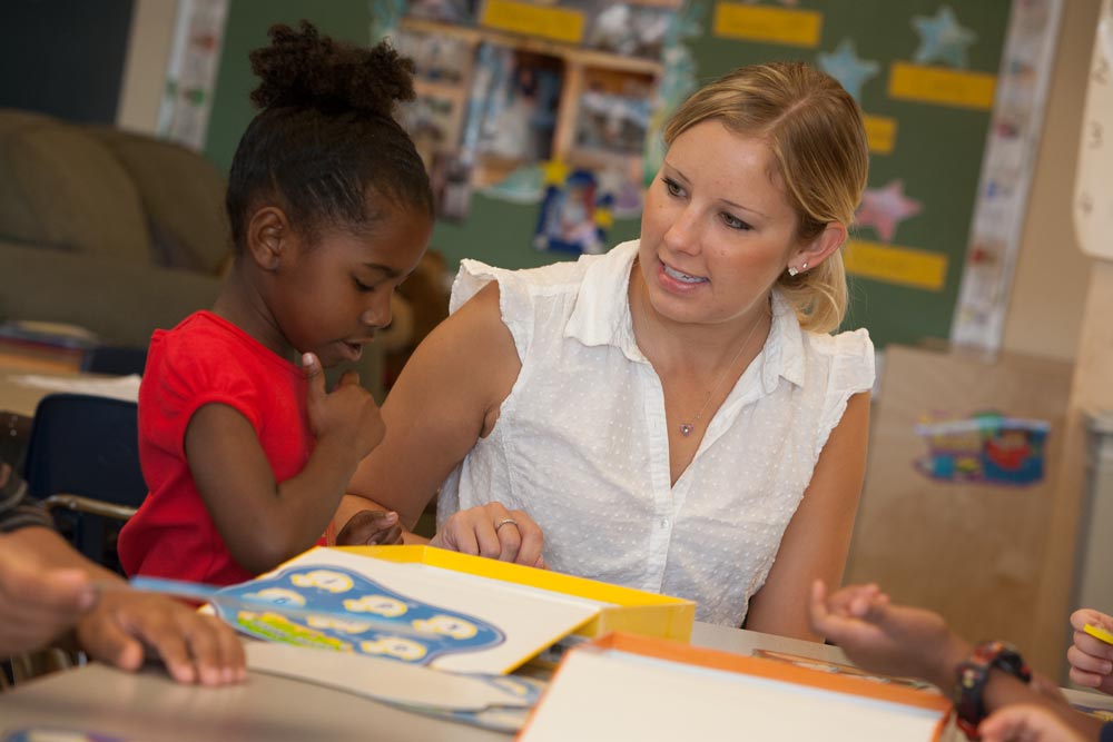 teacher and toddler in corporate child care center