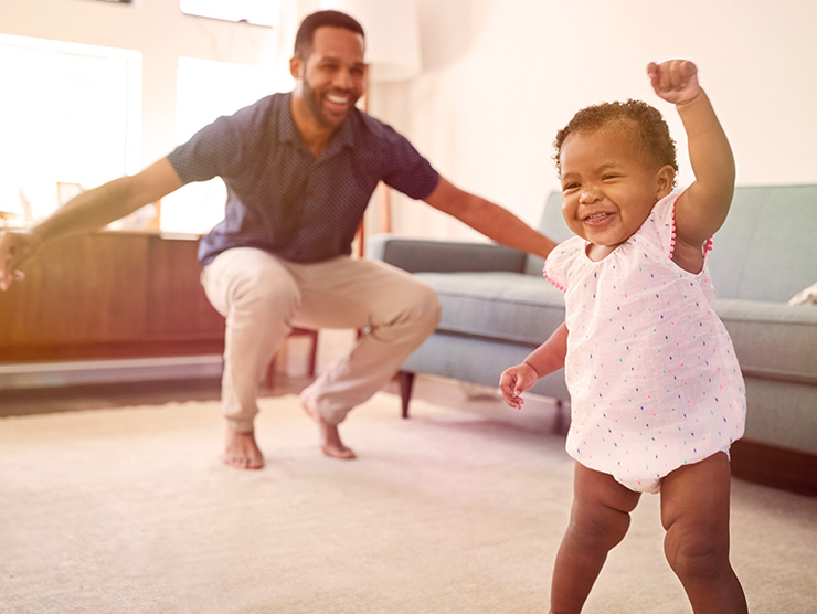 Dad and daughter dancing together at home 