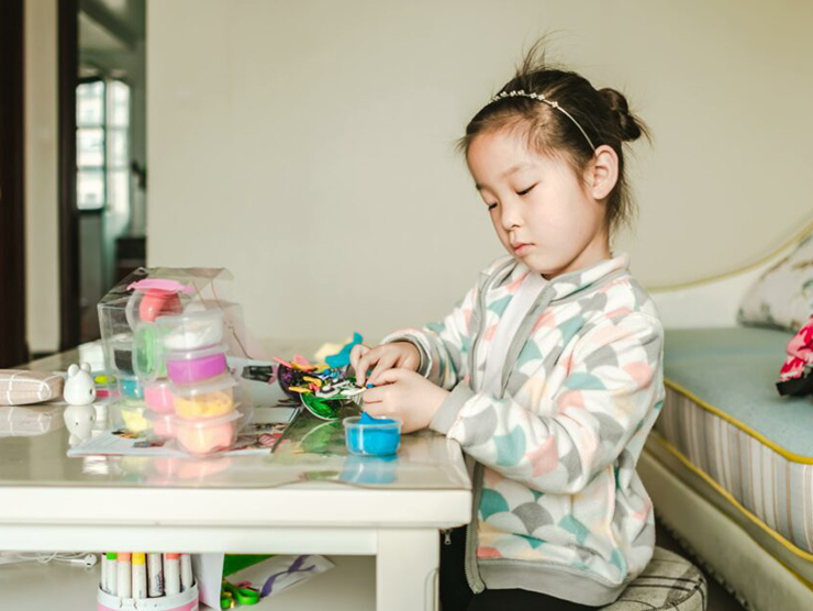 Preschooler building a house with household materials  