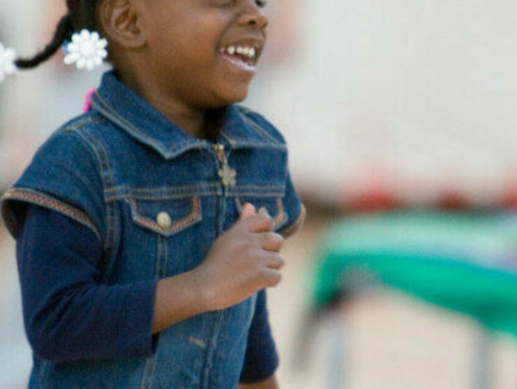 Preschooler running around and smiling at Bright Horizons day care 