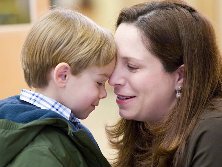 Mother and son touching heads while sharing a touching moment 