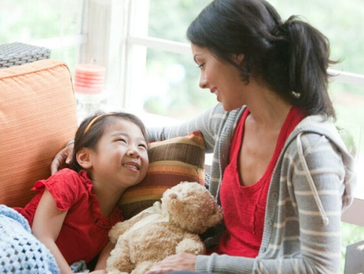 Mother and daughter laughing together at home