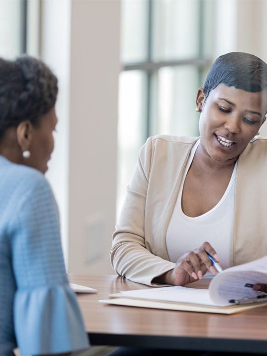 two women looking over financial statement