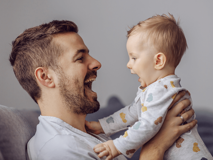 Man holding up child